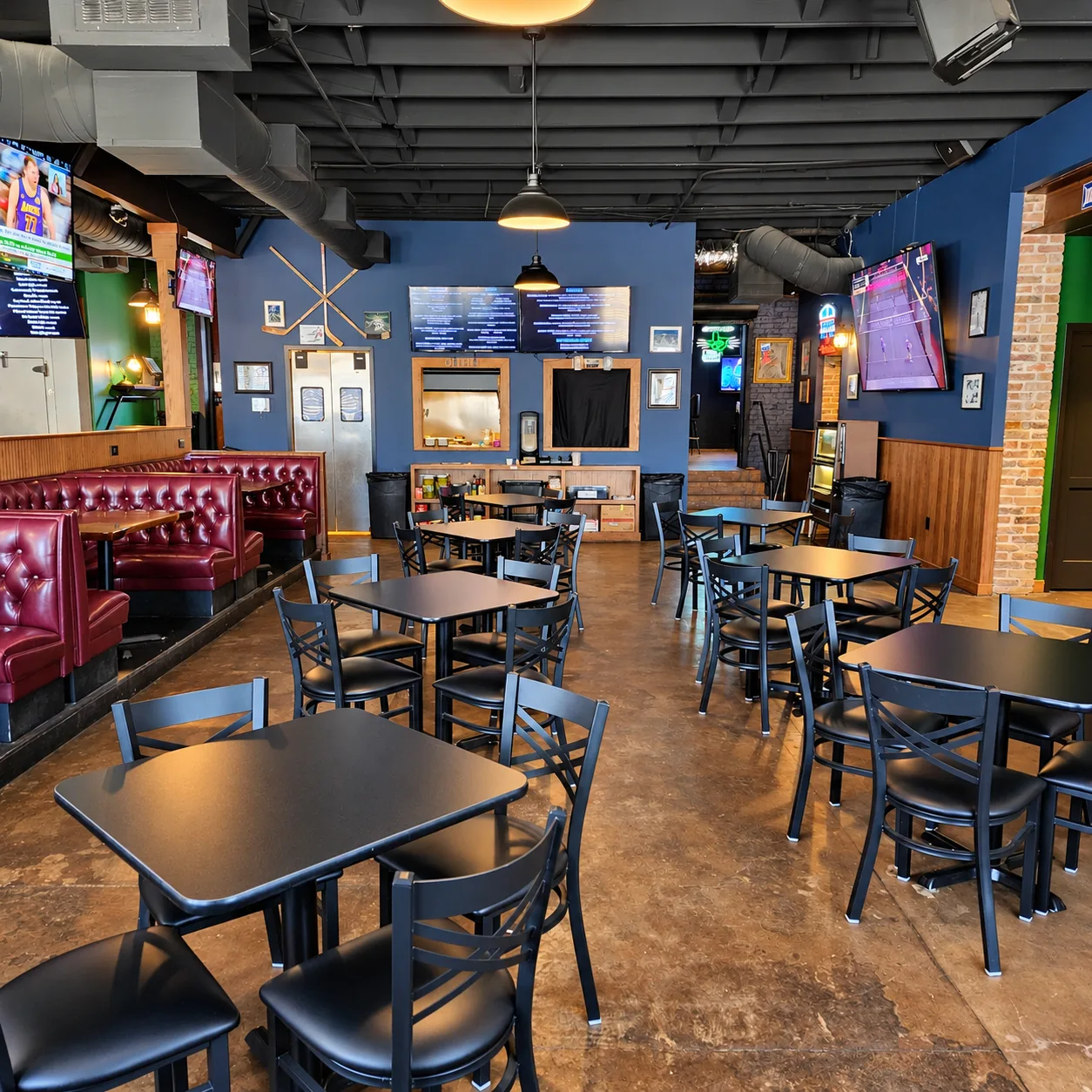 Dining room tables and menu boards inside Morton's Tavern in Fort Worth